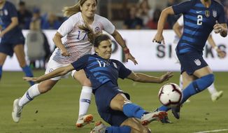 FILE - In this Tuesday, Sept. 4, 2018, file photo, United States&#39; Tobin Heath, bottom, scores a goal in front of Chile&#39;s Geraldine Leyton during the first half of an international friendly soccer match in San Jose, Calif. Less than a year ago Tobin Heath lamented that being injured was the &amp;quot;worst thing in the whole entire world.&amp;quot; Now fit, the Portland Thorns and national team midfielder looks like she’s having the time of her life. (AP Photo/Jeff Chiu, File)