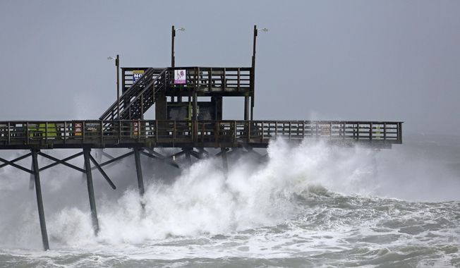 Waves from Hurricane Florence pound the Bogue Inlet Pier in Emerald Isle N.C., Thursday, Sept. 13, 2018. (AP Photo/Tom Copeland)