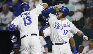 Kansas City Royals&#39; Salvador Perez (13) is congratulated at home plate by Hunter Dozier (17) after hitting a two-run home run in the sixth inning of a baseball game against the Minnesota Twins at Kauffman Stadium in Kansas City, Mo., Thursday, Sept. 13, 2018. (AP Photo/Colin E. Braley)