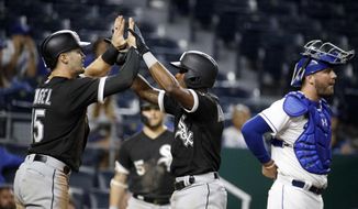Chicago White Sox&#39;s Tim Anderson, center, celebrates with Adam Engel (15) as he crosses the plate past Kansas City Royals catcher Cam Gallagher after hitting a two-run home run during the 12th inning of a baseball game Wednesday, Sept. 12, 2018, in Kansas City, Mo. (AP Photo/Charlie Riedel)