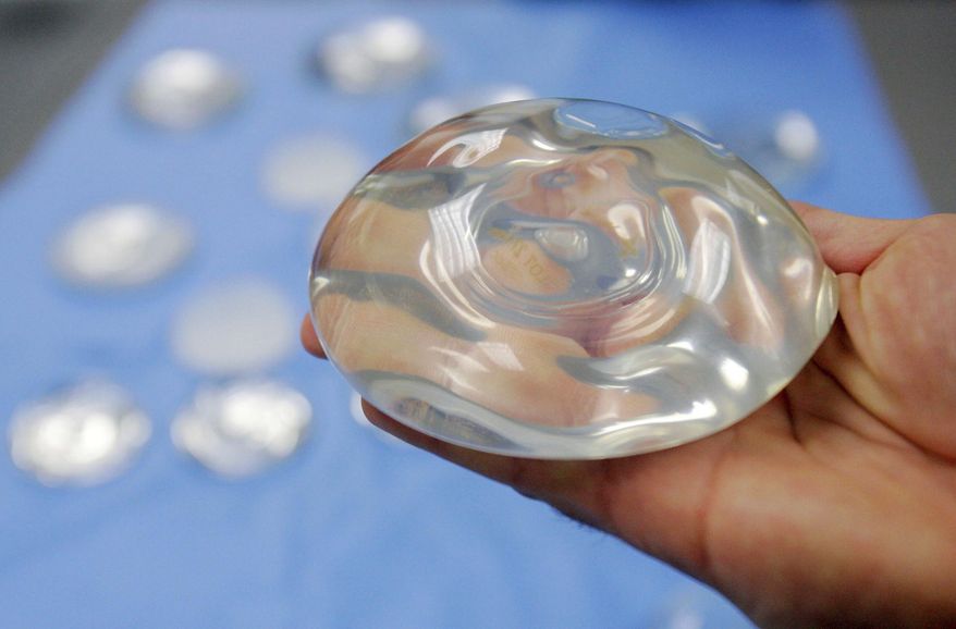 FILE - This Dec. 11, 2006 file photo shows a silicone gel breast implant at a manufacturing facility in Irving, Texas. On Friday, Sept. 14, 2018, U.S. health officials said they will convene a public meeting of medical advisers in 2019 on the safety of breast implants because of growing science on the topic, including an independent analysis that suggests certain rare health problems might be more common in women with implants containing silicone gel. (AP Photo/Donna McWilliam, File)