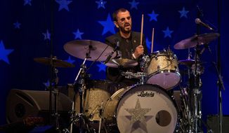 In this June 23, 2018, file photo, musician Ringo Starr performs in Tel Aviv, Israel. Within a week of Paul McCartney playing a surprise show at Grand Central Station, Starr followed a more old-fashioned path Thursday night, Sept. 13, 2018. The 78-year-old drummer and singer headlined a two-hour show at Radio City Music Hall, in New York, with thousands spending much of the performance standing and singing along. (AP Photo/Ariel Schalit, File)
