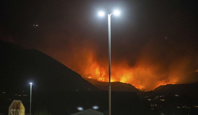 In this Thursday, Sept. 13, 2018, photo, a wildfire burns in Salem, Utah. (Qiling Wang/The Deseret News via AP)