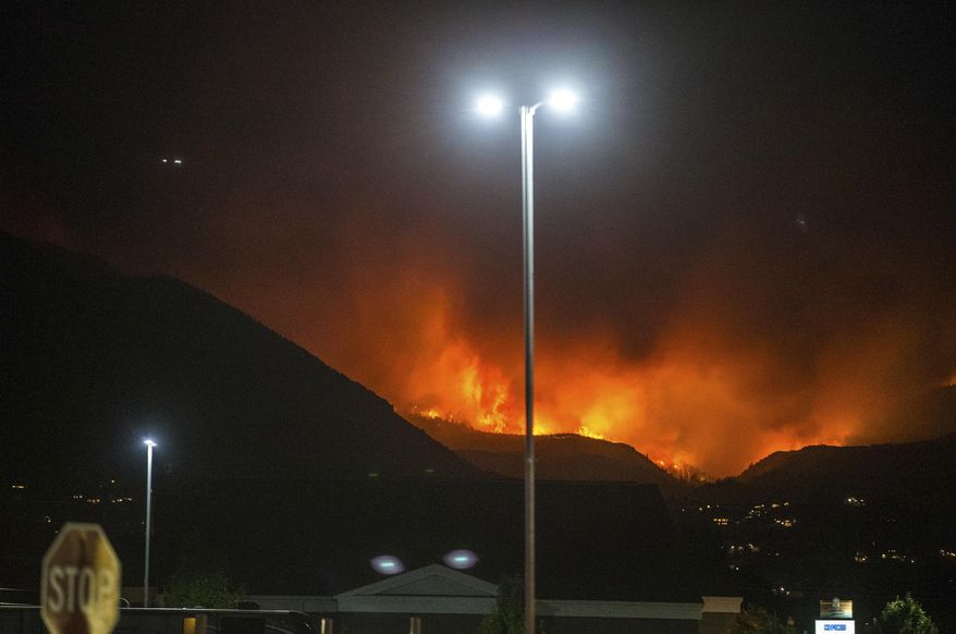 In this Thursday, Sept. 13, 2018, photo, a wildfire burns in Salem, Utah. (Qiling Wang/The Deseret News via AP)