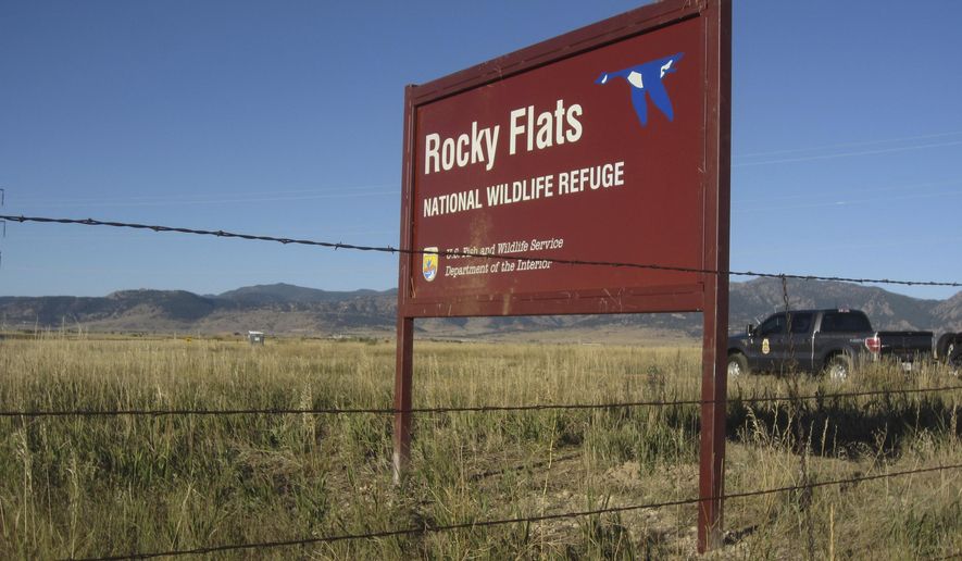 A U.S. Fish and Wildlife Service officer drives into the Rocky Flats National Wildlife Refuge outside Denver on Saturday, Sept. 15, 2018, the first day the refuge was open to the public. The refuge is on the outskirts of a former U.S. government factory that manufactured plutonium triggers for nuclear weapons. (AP Photo/Dan Elliott)