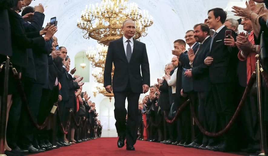 FILE In this file photo taken on Monday, May 7, 2018, Vladimir Putin enters to take the oath during his inauguration ceremony as Russia&#39;s new president in the Grand Kremlin Palace in Moscow, Russia. Experts say Putin isn’t necessarily dictating every Russian influence campaign abroad. Some accused of meddling in the 2016 U.S. elections appear to be ambitious individuals taking the initiative based on signals from the presidential entourage. (AP Photo/Alexander Zemlianichenko, Pool, File)
