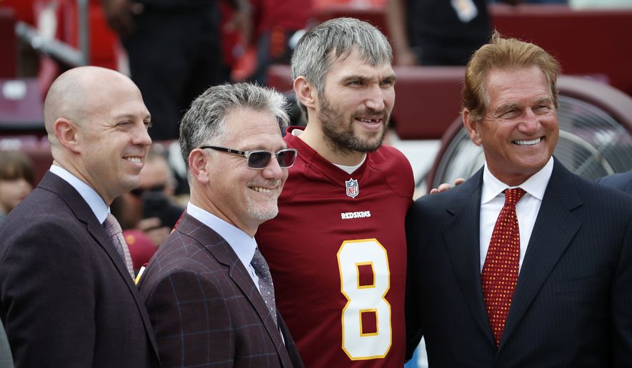 Washington Capitals' Alex Ovechkin, second from right, poses for a photo before an NFL football game between the Washington Redskins and the Indianapolis Colts, Sunday, Sept. 16, 2018, in Landover, Md. (AP Photo/Alex Brandon)
