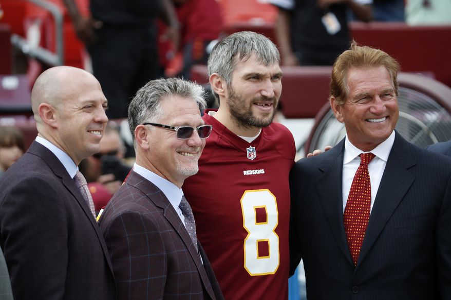 Washington Capitals' Alex Ovechkin, second from right, poses for a photo before an NFL football game between the Washington Redskins and the Indianapolis Colts, Sunday, Sept. 16, 2018, in Landover, Md. (AP Photo/Alex Brandon)