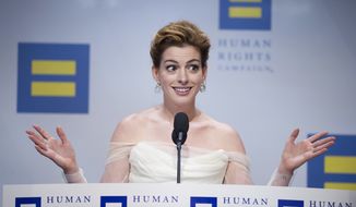 Actress Anne Hathaway addresses the Human Rights Campaign (HRC) National Dinner after receiving the group&#39;s National Equality Award, in Washington, Saturday, Sept. 15, 2018. (AP Photo/Cliff Owen)
