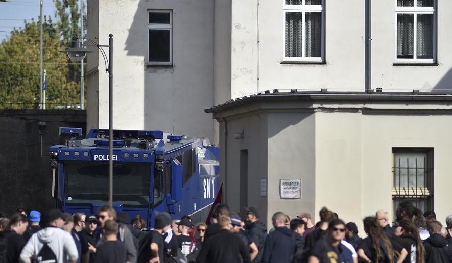 Protesters against a far-right demontration gather at the train station of Koethen, Germany, Sunday, Sept. 16, 2018. Far-right organizations including the anti-Islam group PEGIDA say they want to protest the death a week ago of a 22-year-old German who died after a dispute with two migrants. (dpa via AP)