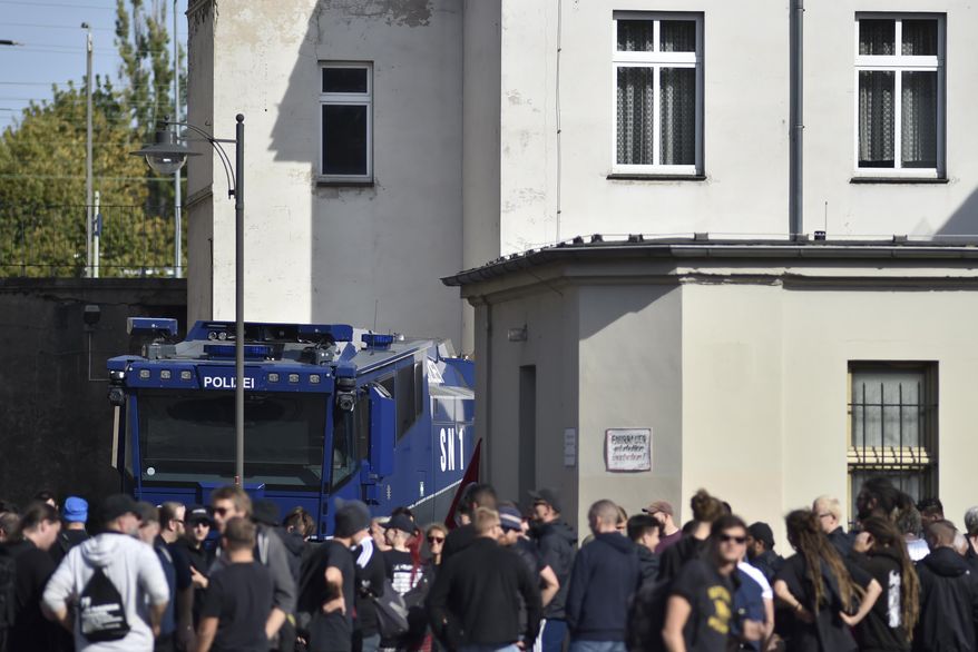 Protesters against a far-right demontration gather at the train station of Koethen, Germany, Sunday, Sept. 16, 2018. Far-right organizations including the anti-Islam group PEGIDA say they want to protest the death a week ago of a 22-year-old German who died after a dispute with two migrants. (dpa via AP)