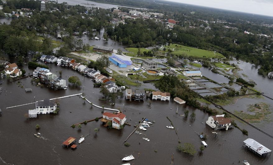 Homes and a marina are flooded as a result of high tides and rain from hurricane Florence which moved through the area in Jacksonville, N.C., Sunday, Sept. 16, 2018. (AP Photo/Steve Helber)