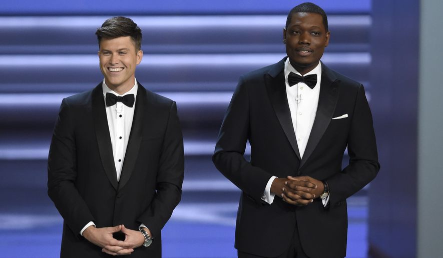 Hosts Colin Jost, left, and Michael Che speak at the 70th Primetime Emmy Awards on Monday, Sept. 17, 2018, at the Microsoft Theater in Los Angeles. (Photo by Chris Pizzello/Invision/AP)