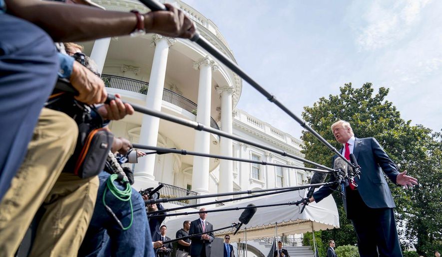 A former McCain campaign adviser says that voters are becoming weary of the slams against President Trump and losing their power.
President Trump faces the press and their many microphones during a brief encounter on the White House lawn. (AP Photo/Andrew Harnick) (Associated Press)