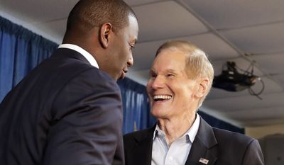Florida Democratic gubernatorial candidate Andrew Gillum, left, greets Sen. Bill Nelson, D-Fla. before speaking to supporters at a Democratic Party rally Friday, Aug. 31, 2018, in Orlando, Fla. (AP Photo/John Raoux)