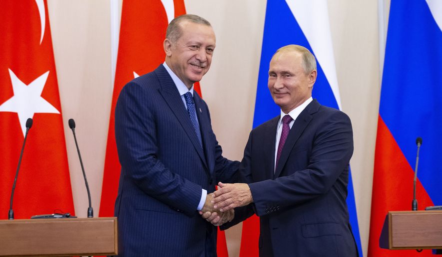 Russian President Vladimir Putin, right, and Turkish President Recep Tayyip Erdogan shake hands after their joint news conference following the talks in the Bocharov Ruchei residence in the Black Sea resort of Sochi in Sochi, Russia, Monday, Sept. 17, 2018. (AP Photo/Alexander Zemlianichenko, Pool) ** FILE **