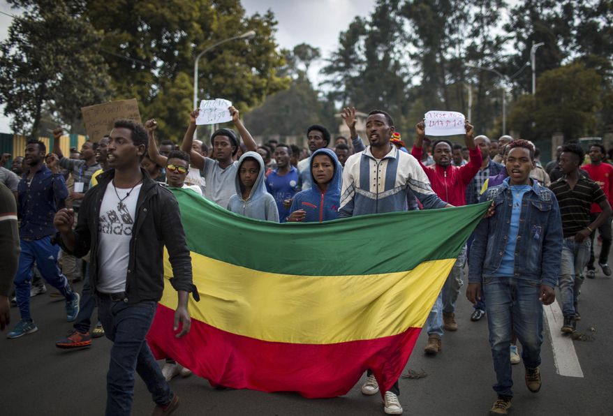 Thousands of protestors from the capital and those displaced by ethnic-based violence over the weekend in Burayu, demonstrate to demand justice from the government in Addis Ababa, Ethiopia Monday, Sept. 17, 2018. Several thousand Ethiopians have gone out onto the streets of the capital to protest ethnic-based attacks in the outskirts of the city in which more than 20 people died over the weekend. Three banners in Amharic from left to right read "Justice for the people of Amhara, Tigray and Southerners", "Stop ethnic-based attacks" and "One mouth, but two tongues". (AP Photo/Mulugeta Ayene)