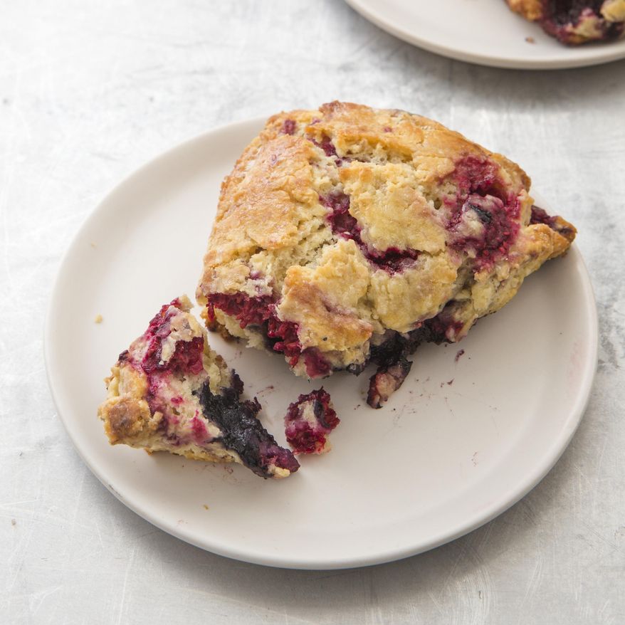 This undated photo provided by America's Test Kitchen in September 2018 shows a mixed berry scone in Brookline, Mass. This recipe appears in the cookbook “All-Time Best Brunch.” (Joe Keller/America's Test Kitchen via AP)