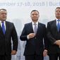 Polish President Andrzej Duda, center, poses next to Romanian counterpart Klaus Iohannis, right, and the head of Romania&#x27;s Chamber of Commerce and Industry at the opening of the Three Seas Initiative in Bucharest, Romania, Monday, Sept. 17, 2018. U.S. President Donald Trump has reaffirmed Washington&#x27;s support for a business summit that aims to boost connectivity in Eastern Europe and improve ties between the region and the U.S. and European Union. (AP Photo/Andreea Alexandru)