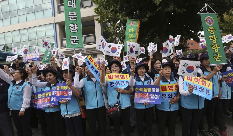 South Koreans wave their national flags during a rally to wish for the successful inter-Korean summit near the presidential Blue House in Seoul, Tuesday, Sept. 18, 2018. South Korean President Moon Jae-in said Monday that he will push for &amp;quot;irreversible, permanent peace,&amp;quot; and for better dialogue between Pyongyang and Washington, during &amp;quot;heart-to-heart&amp;quot; talks with North Korean leader Kim Jong Un this week. The signs read: &amp;quot; Denuclearization.&amp;quot; (AP Photo/Ahn Young-joon)
