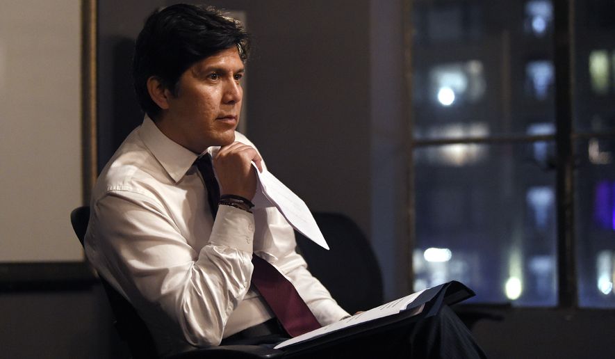 Kevin de Leon, California state Senate president pro tem and Democratic candidate for the U.S. Senate, looks over his speech before speaking at an election party Tuesday, June 5, 2018, in Los Angeles. (AP Photo/Mark J. Terrill)