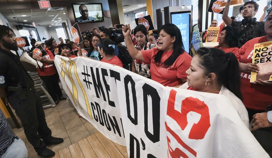 Workers protest inside of a McDonald&#39;s restaurant in south Los Angeles on Tuesday, Sept. 18, 2018. Emboldened by the #MeToo movement, McDonald&#39;s workers have voted to stage a one-day strike next week at restaurants in 10 cities in hopes of pressuring management to take stronger steps against on-the-job sexual harassment. (AP Photo/Richard Vogel)