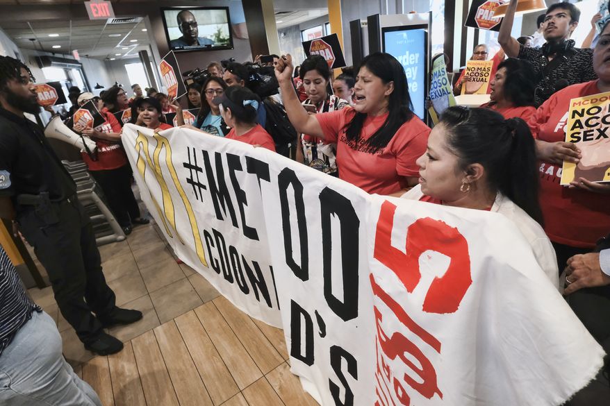 Workers protest inside of a McDonald&#x27;s restaurant in south Los Angeles on Tuesday, Sept. 18, 2018. Emboldened by the #MeToo movement, McDonald&#x27;s workers have voted to stage a one-day strike next week at restaurants in 10 cities in hopes of pressuring management to take stronger steps against on-the-job sexual harassment. (AP Photo/Richard Vogel)