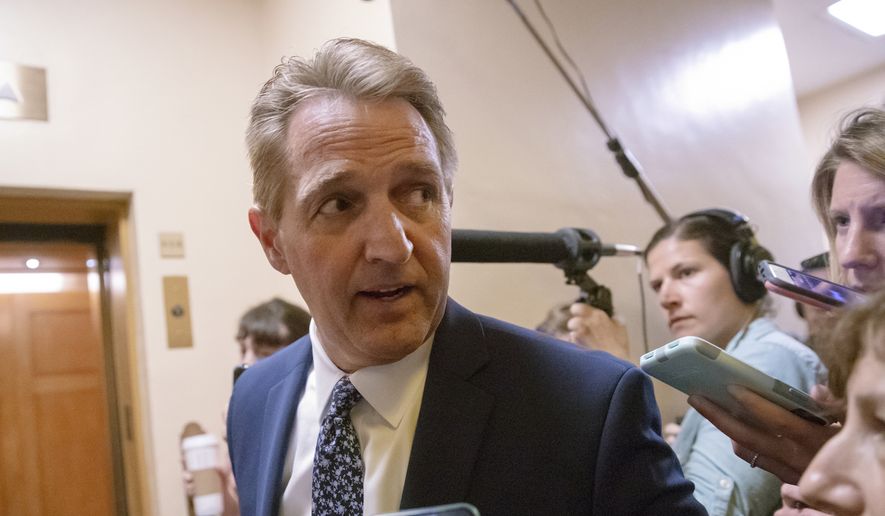 Sen. Jeff Flake, R-Ariz., a member of the Judiciary Committee, responds to reporters' questions on Supreme Court nominee Brett Kavanaugh amid scrutiny of a woman's claim he sexually assaulted her at a party when they were in high school, on Capitol Hill in Washington, Tuesday, Sept. 18, 2018. (AP Photo/J. Scott Applewhite) ** FILE **