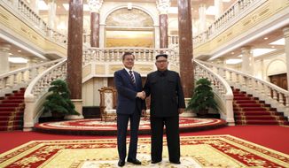 North Korean leader Kim Jong Un, right, shakes hands with South Korean President Moon Jae-in before their summit at the headquarters of the Central Committee of the Workers&#39; Party in Pyongyang, North Korea, Tuesday, Sept. 18, 2018. (Pyongyang Press Corps Pool via AP)