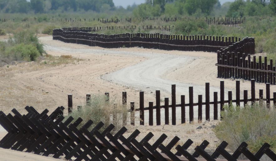 This June 15, 2017, photo provided by Kenneth Madsen, shows a post-on-rail style of fence along the flood plain of the Colorado River between Arizona and Baja California, which is typical of border wall fences placed in environmentally sensitive areas or in areas prone to flooding. A new photo exhibit by Madsen opening Wednesday, Sept. 19, 2018, at the Ohio State University-Newark campus, &amp;quot;Up Close with U.S.-Mexico Border Barriers,” highlights different types of border wall fencing. (Kenneth Madsen via AP)