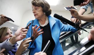 Sen. Dianne Feinstein, D-Calif., is surrounded by reporters as she arrives for a vote, Tuesday, Sept. 18, 2018, on Capitol Hill in Washington. (AP Photo/Jacquelyn Martin)