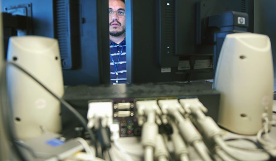 Computer forensic examiner Gil Moreno works on several hard drives association with a crime, at the Department of Defense Cyber Crime Center in Linthicum, Thursday, Aug. 11, 2011. Hackers and hostile nations are launching increasingly sophisticated cyberattacks against U.S. defense contractors. And the Pentagon is extending a program to help protect its prime suppliers, while serving as a possible model for other government agencies. Pentagon analysts are investigating a growing number of cases involving the mishandling or removal of classified data from military and corporate systems. Defense officials say intrusions into defense networks are now close to 30 percent of the Pentagon&#x27;s Cyber Crime Center&#x27;s workload. (AP Photo/Cliff Owen) **FILE**