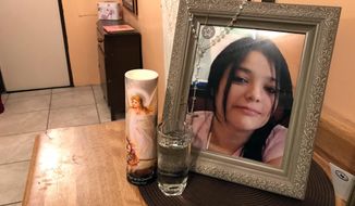 A framed photo of Melissa Ramirez sits at the end of a makeshift altar in her mother&#x27;s home in Rio Bravo, Texas, on Tuesday, Sept. 18, 2018. (AP Photo/Susan Montoya Bryan)