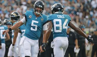 FILE - In this Sunday, Sept. 16, 2018, file photo, Jacksonville Jaguars quarterback Blake Bortles (5) celebrates his touchdown pass to wide receiver Keelan Cole (84) during the first half of an NFL football game against the New England Patriots in Jacksonville, Fla. The Jaguars might as well dub this the Payback Tour 2018. It started last week against when Jaguars won against two-time defending AFC champion New England. Now, the Jaguars get AFC South rival, the Tennessee Titans. (AP Photo/Stephen B. Morton)