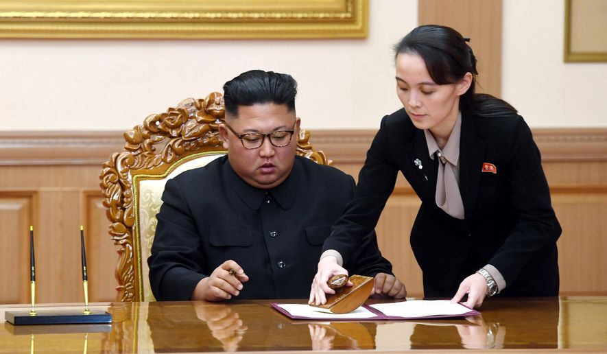 Kim Yo Jong, right, sister of North Korean leader Kim Jong-un, helps Kim sign joint statement following the summit with South Korean President Moon Jae-in at the Paekhwawon State Guesthouse in Pyongyang, North Korea, Wednesday, Sept. 19, 2018. (Pyongyang Press Corps Pool via AP)