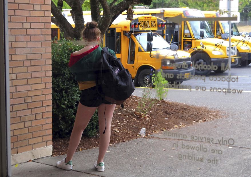 A student waits for a ride after school. (AP Photo/Gillian Flaccus) **FILE**