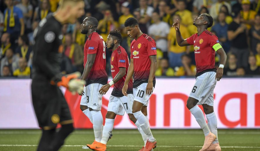 Manchester United&#39;s Paul Pogba, right, celebrates after scoring  during the Champions League group H soccer match between Young Boys and Manchester United at the Stade de Suisse in Berne, Switzerland, Wednesday, Sept. 19, 2018. (Anthony Anex/Keystone via AP)