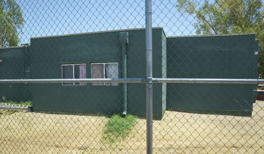 FILE - In this June 28, 2018, file photo, buildings that house juveniles and operations on the grounds of Southwest Key Campbell, a shelter for children that have been separated form their parents in Phoenix, Ariz. are seen. Arizona officials have moved to revoke the licenses for the nonprofit that houses immigrant children after it missed a deadline to show that all its employees passed background checks. (AP Photo/Carolyn Kaster, file)