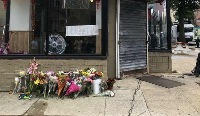 A makeshift memorial for Wendy Martinez grows outside a restaurant in Northwest D.C. Martinez was fatally stabbed in the Logan Circle neighborhood on Tuesday, Sept. 18, and Metropolitan Police announced the arrest of a suspect, Anthony Crawford, in a Sept. 20 news conference. (Jeff Mordock/The Washington Times)