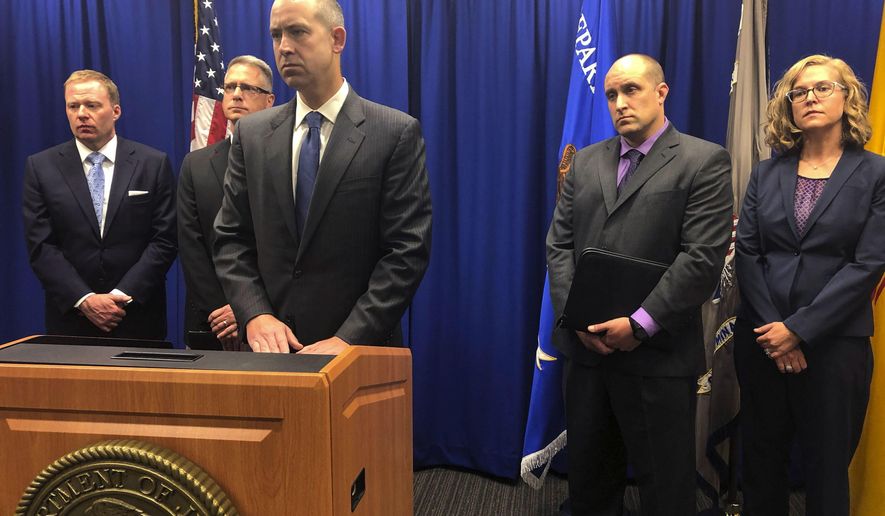 U.S. Attorney John Anderson, center at podium, speaks about the investigation into a fugitive Catholic priest who is accused of sex abuse at a news conference Friday, Sept. 21, 2018, in Albuquerque, N.M. Federal authorities said FBI agents returned 80-year-old Arthur Perrault to New Mexico on Friday to face child sexual abuse charges after a year in the custody of Moroccan authorities. (AP Photo/Mary Hudetz)