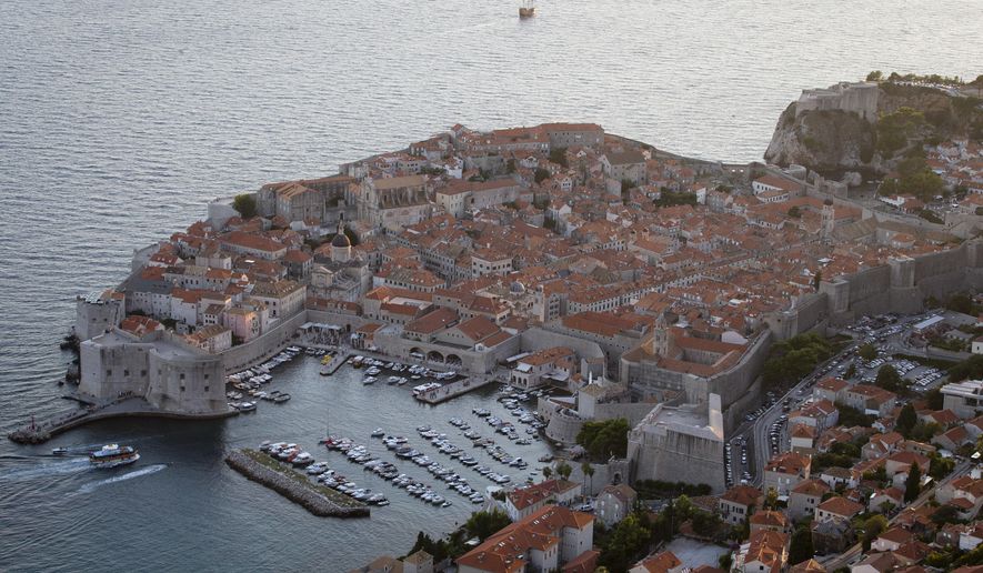 This Sept. 4, 2018 photo shows the old town of Dubrovnik from a hill above the city. Crowds of tourist are clogging the entrances into the ancient walled city, a UNESCO World Heritage Site, as huge cruise ships unload thousands more daily. (AP Photo/Darko Bandic)