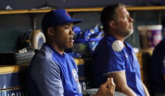 FILE - In this Aug. 21, 2018, file photo, Chicago Cubs&#39; Addison Russell flips a baseball in the dugout in the sixth inning of a baseball game against the Detroit Tigers in Detroit, Russell was placed on administrative leave Friday, Sept. 21, 2018, following fresh allegations of domestic violence by his ex-wife.(AP Photo/Paul Sancya, File) **FILE**