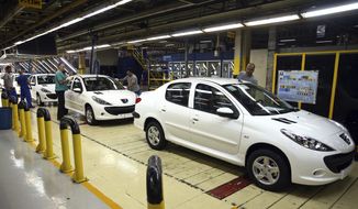 In this Sunday, Sept. 9, 2018 photo, a line of Peugeot cars rolls out at the state-run Iran Khodro automobile manufacturing plant, just outside Tehran, Iran. As Iran&#39;s rial currency suffers precipitous falls against the U.S. dollar, cars are growing more and more expensive. Meanwhile, foreign manufacturers are pulling out from the country and foreign-produced parts are becoming harder to find. That&#39;s a problem for one of the Mideast&#39;s biggest countries and home to 80 million people. (AP Photo/Ebrahim Noroozi)