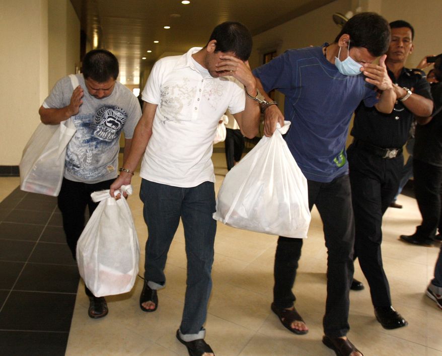 FILE - In this May 17, 2012, file photo, Mexican brothers, from left, Luis Alfonso Gonzalez Villarreal, Simon Gonzalez Villarreal and Jose Regino Gonzalez Villarreal, leave a courthouse in Kuala Lumpur, Malaysia. A lawyer for the Mexican brothers convicted of drug trafficking said Friday, Sept. 21, 2018, death sentences for the three men have been commuted to prison terms. They are serving new sentences of 30 years in prison, starting from the date of the royal pardon. (AP Photo/Lai Seng Sin, File)