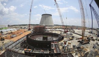 FILE- This June 13, 2014, file photo, shows construction on a new nuclear reactor at Plant Vogtle power plant in Waynesboro, Ga. A group of Georgia lawmakers wants a “cost cap” in the construction of a nuclear power plant near Augusta to protect blown budgets from being passed on to consumers. Two reactors being built at Plant Vogtle are billions of dollars over budget. (AP Photo/John Bazemore, File)