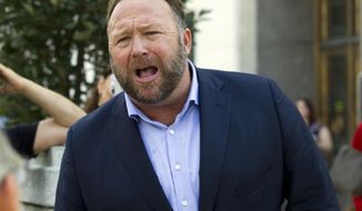 In this Sept. 5, 2018, file photo conspiracy theorist Alex Jones speaks outside of the Dirksen building of Capitol Hill after listening to Facebook COO Sheryl Sandberg and Twitter CEO Jack Dorsey testify before the Senate Intelligence Committee on &#39;Foreign Influence Operations and Their Use of Social Media Platforms&#39; on Capitol Hill in Washington. (AP Photo/Jose Luis Magana, File)