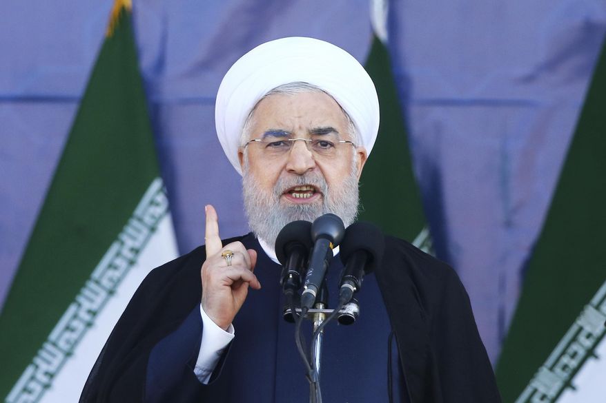 Iran's President Hassan Rouhani speaks at a military parade marking the 38th anniversary of Iraq's 1980 invasion of Iran, in front of the shrine of the late revolutionary founder, Ayatollah Khomeini, outside Tehran, Iran, Saturday, Sept. 22, 2018. Gunmen attacked the military parade, killing at least eight members of the elite Revolutionary Guard and wounding 20 others, state media said. (AP Photo/Ebrahim Noroozi)