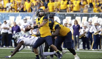 West Virginia quarterback Will Grier (7) pass the ball during the first half of an NCAA college football game against Kansas State Saturday, Sept.22, 2018, in Morgantown, W.Va. (AP Photo/Raymond Thompson)