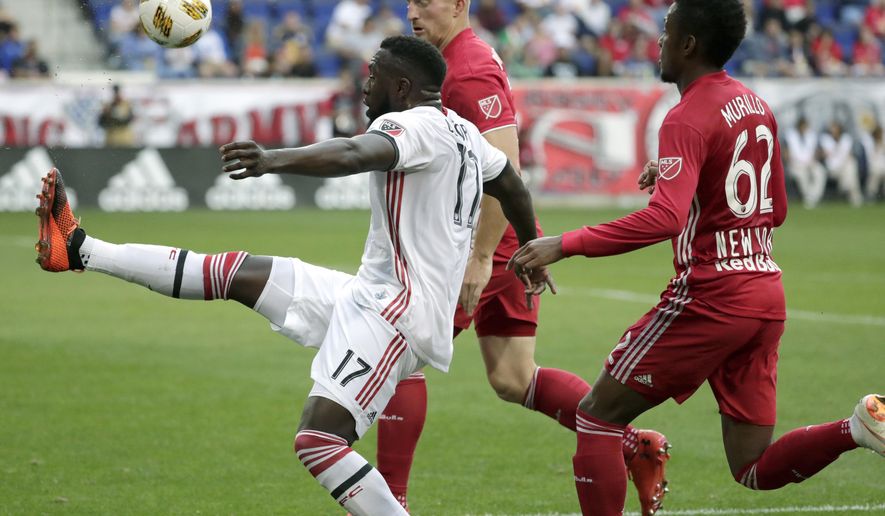 Toronto FC forward Jozy Altidore, left, tries to control the ball as New York Red Bulls defender Tim Parker, center, and defender Michael Murillo apply pressure during the first half of a soccer game, Saturday, Sept. 22, 2018, in Harrison, N.J. (AP Photo/Julio Cortez)