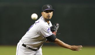 Colorado Rockies pitcher German Marquez throws in the first inning during a baseball game against the Arizona Diamondbacks, Friday, Sept. 21, 2018, in Phoenix. (AP Photo/Rick Scuteri)